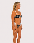 Black and white Flying Fox bikini bottom on model, 5'4" wearing size Small
Side view of black and white bikini bottom from Somewhere On A Yacht
Flying Fox black and white bikini bottom styled on a yacht sundeck