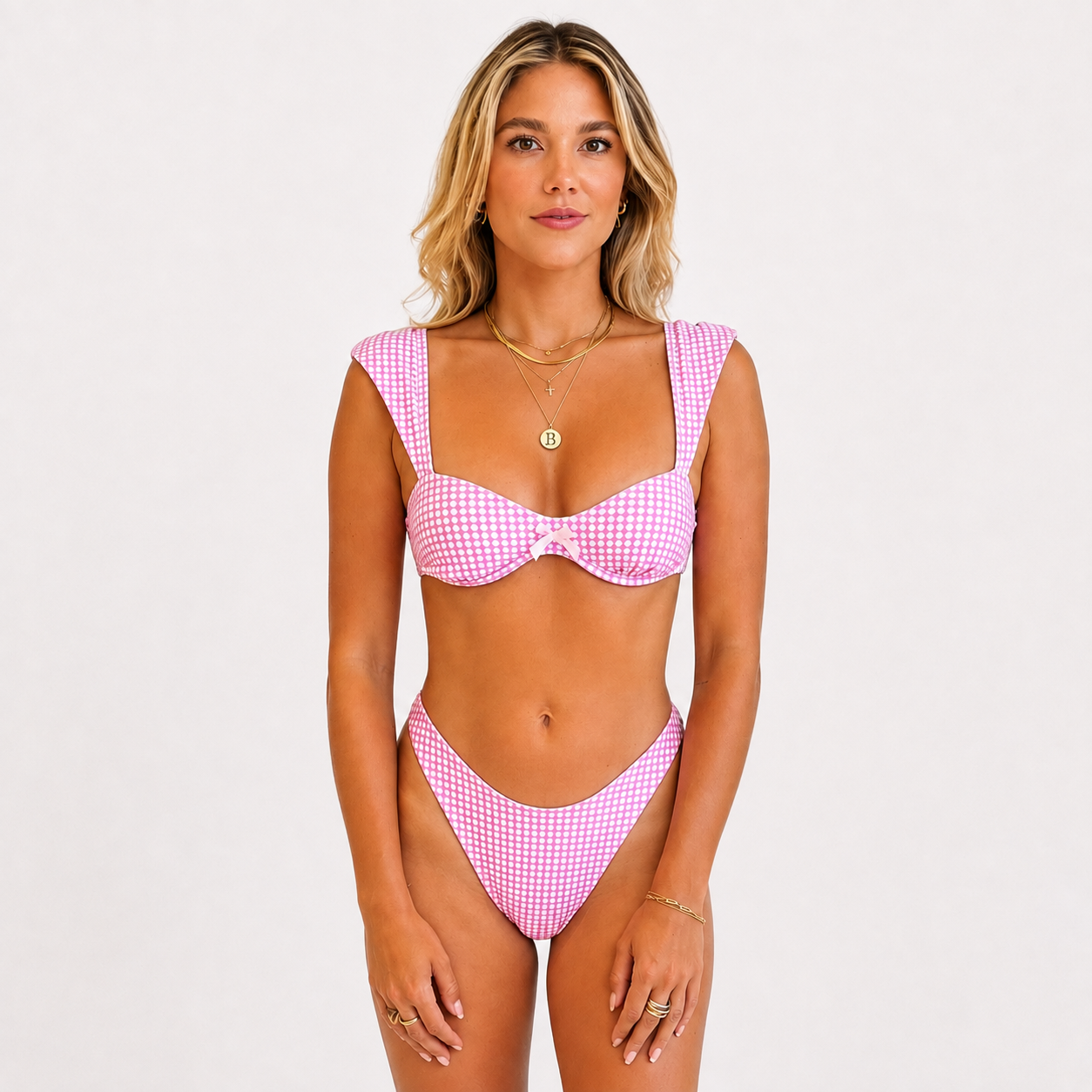 Baby pink polka dot Alfa Nero bikini top on model, 5'4" wearing size Small