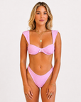 Baby pink polka dot Alfa Nero bikini top on model, 5'4" wearing size Small