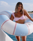 Alfa Nero baby pink bikini top styled on a yacht