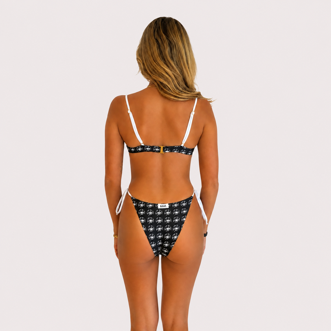 Black and white Flying Fox bikini bottom on model, 5'4" wearing size Small
Back view of black and white bikini bottom from Somewhere On A Yacht
Flying Fox black and white bikini bottom styled on a yacht sundeck
