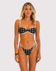 Black and white Flying Fox bikini bottom on model, 5'4" wearing size Small
Front view of black and white bikini bottom from Somewhere On A Yacht
Flying Fox black and white bikini bottom styled on a yacht sundeck
